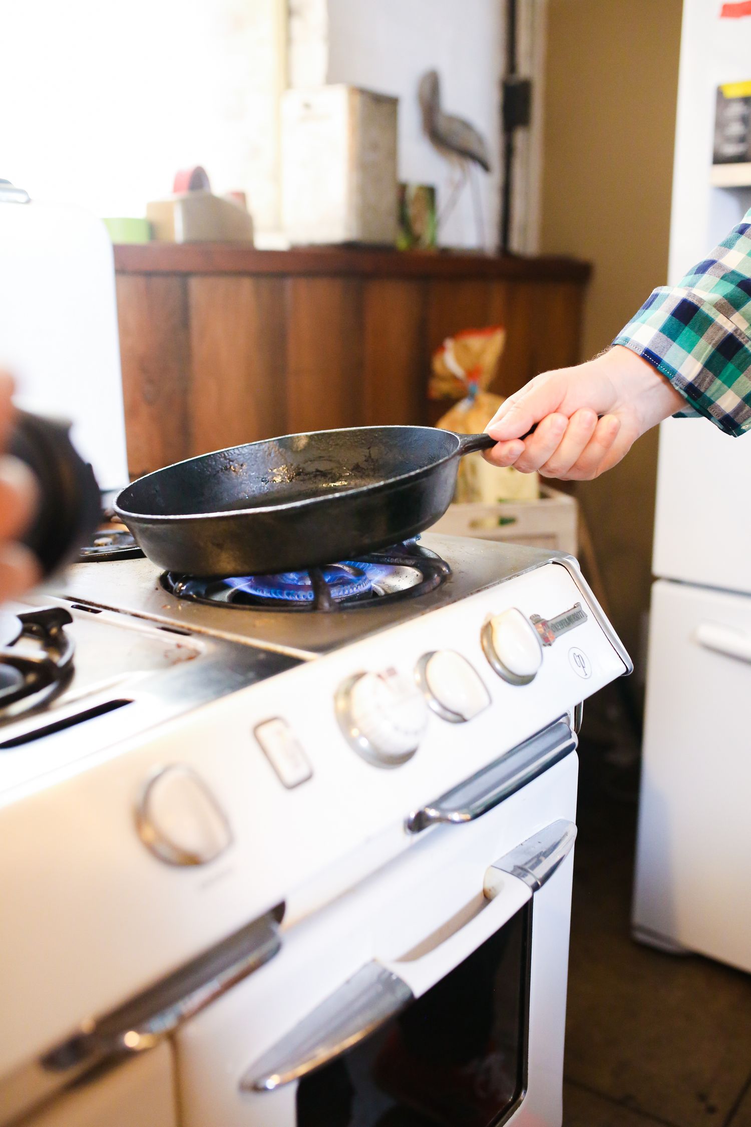 Person holding a frying pan