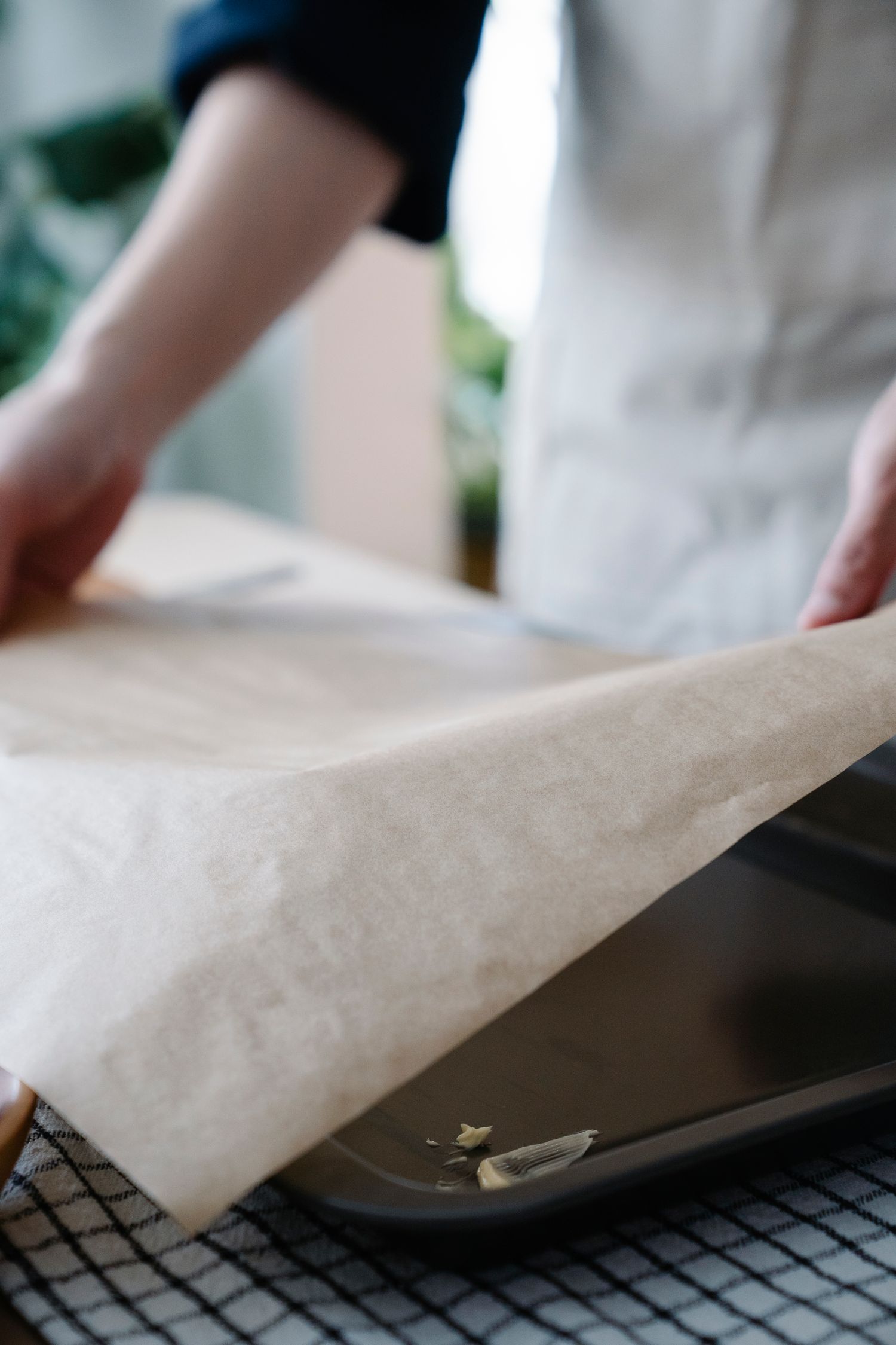 Baking sheet being lined with paper