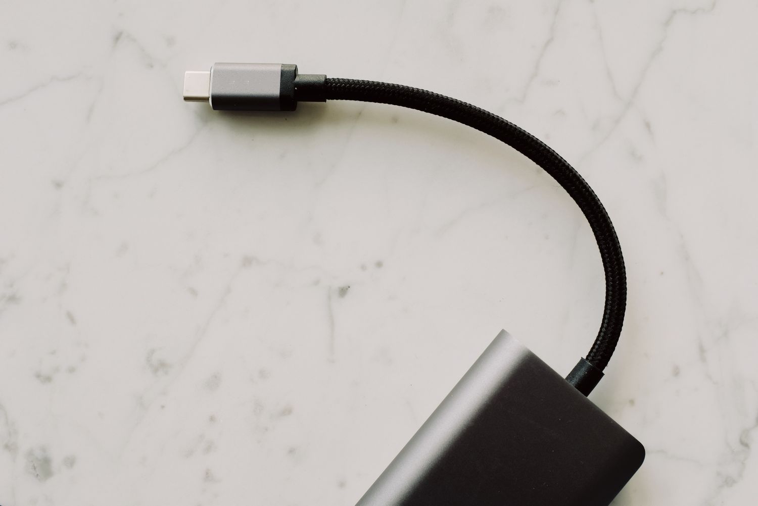 USB-C cable and adapter on a light surface