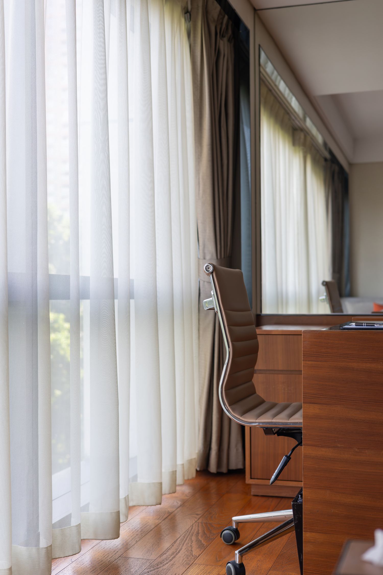 Office chair beside a sunlit window