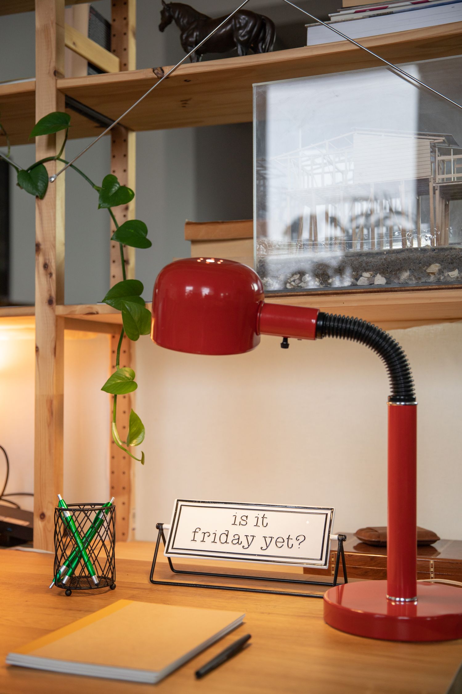 Red desk lamp on a wooden table