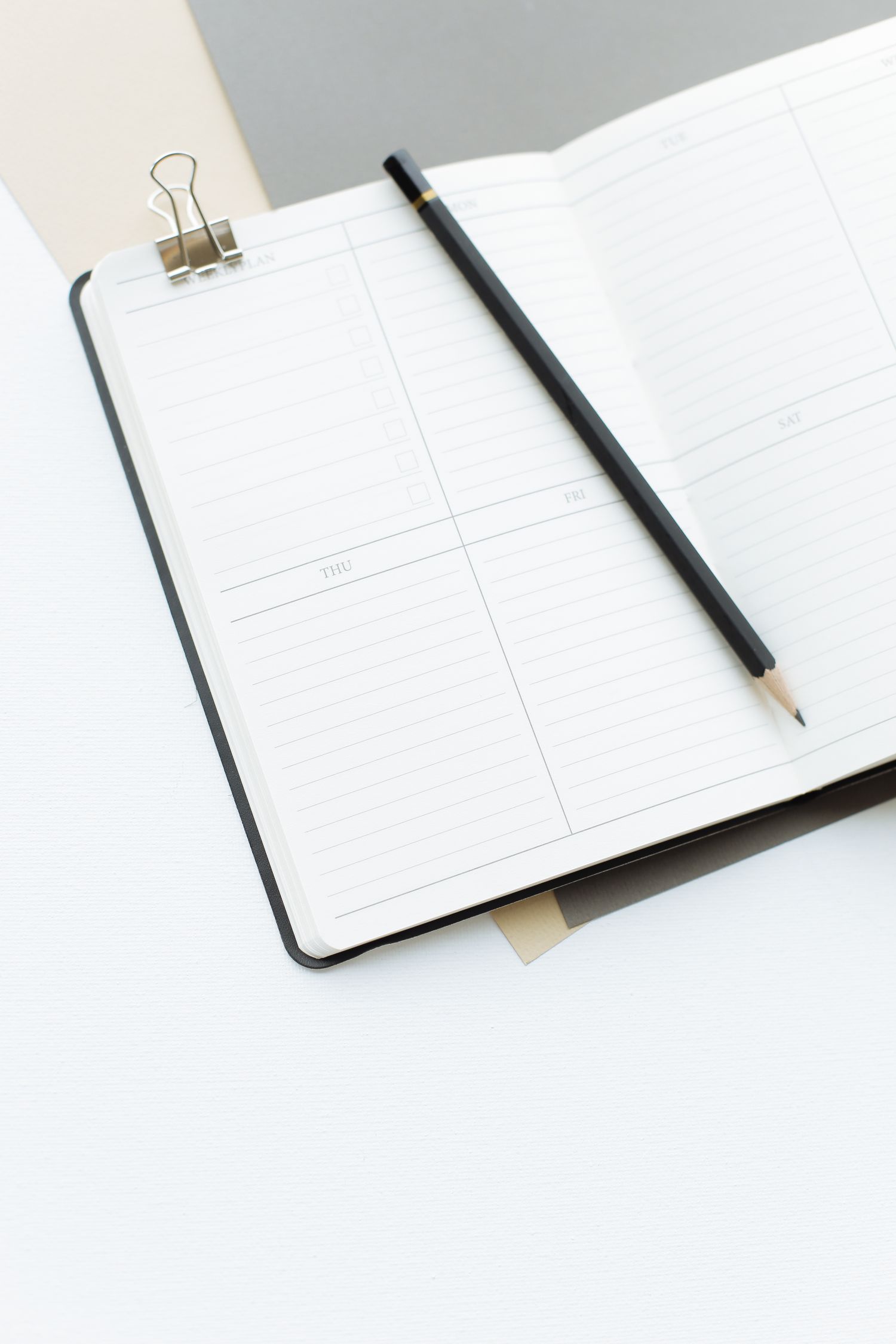 Open notebook with a pencil on a desk