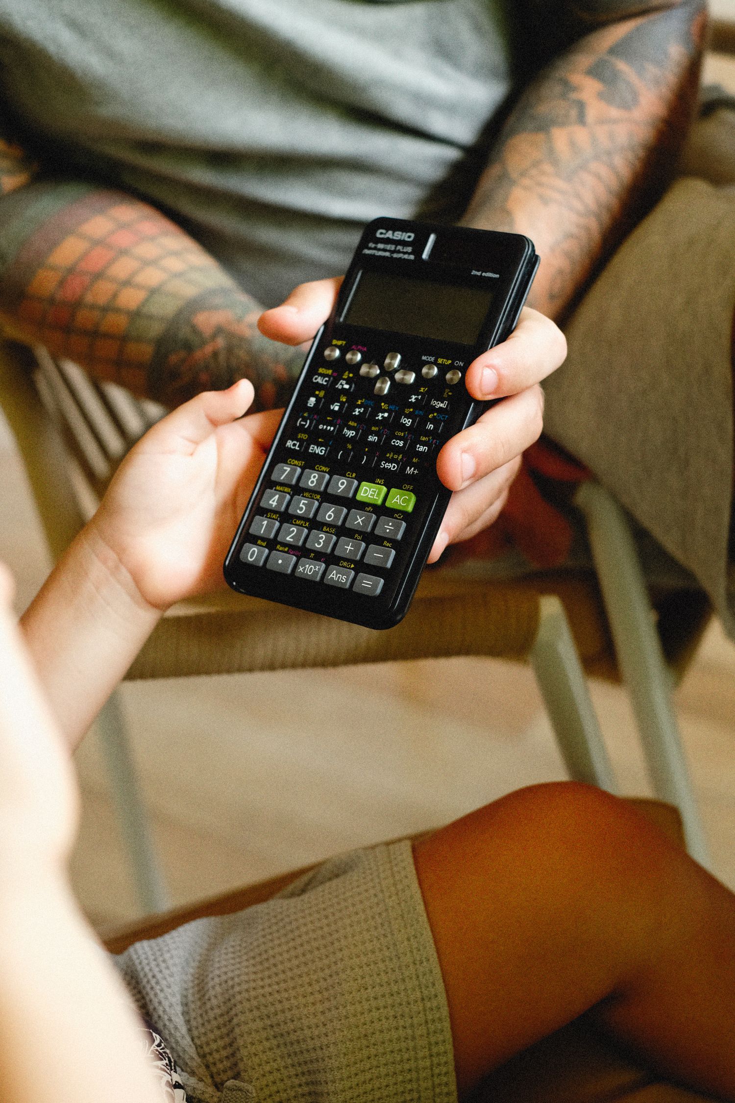 Hands holding a calculator