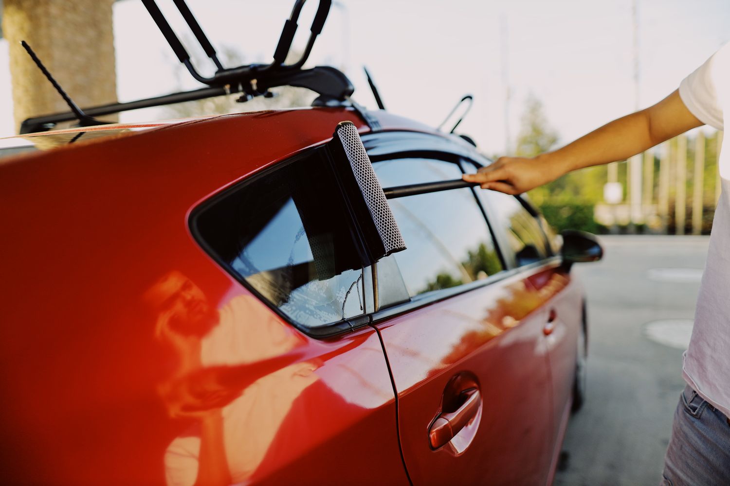 Window squeegee being used on a car window